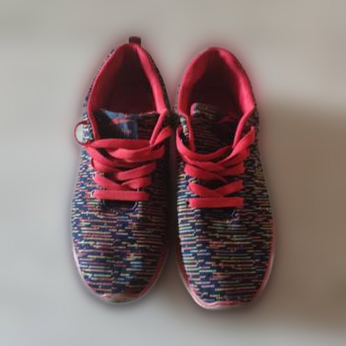 Red sneakers sharp in front of a blurred floor