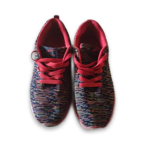 Red sneakers on a pure white background with a soft shadow